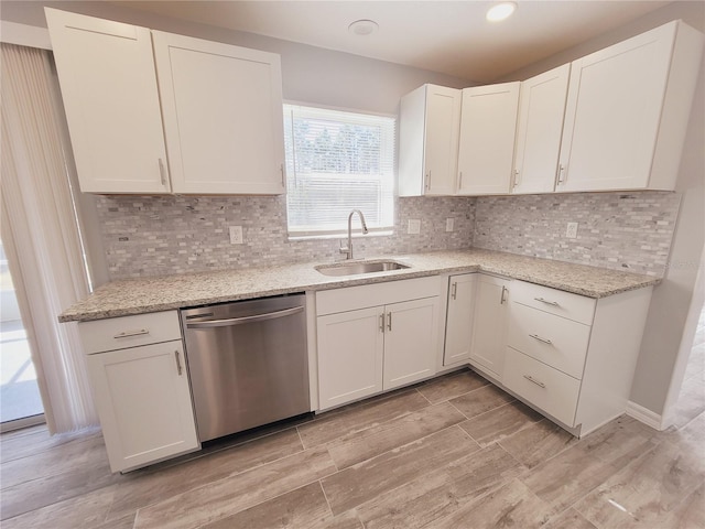 kitchen with sink, white cabinets, and dishwasher