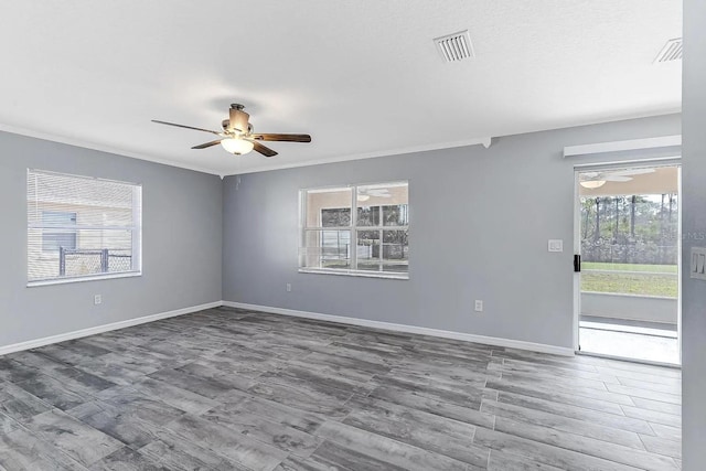 unfurnished room featuring ceiling fan, wood-type flooring, and ornamental molding