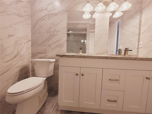 bathroom featuring vanity, hardwood / wood-style flooring, tile walls, and toilet