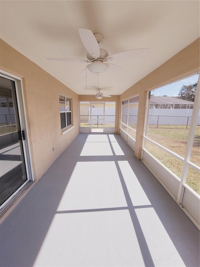 sunroom / solarium featuring ceiling fan