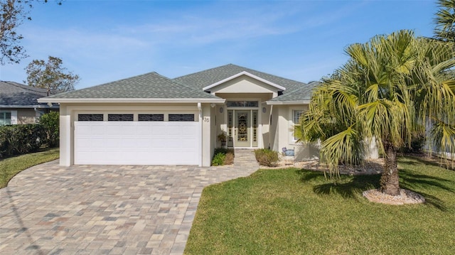 view of front of property featuring a garage and a front yard