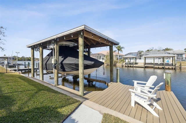 view of dock featuring a water view and a yard