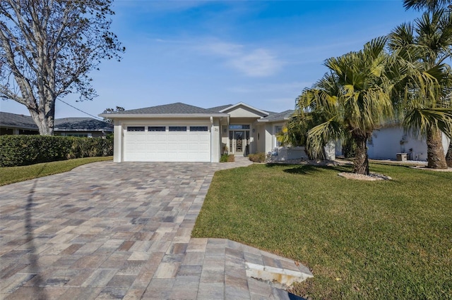 view of front of house with a garage and a front lawn