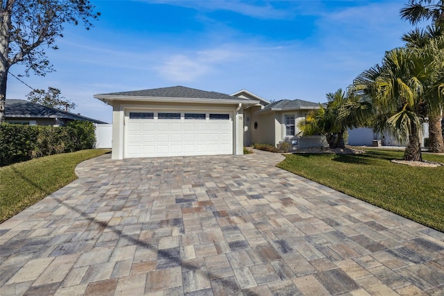 view of front of home with a garage and a front yard