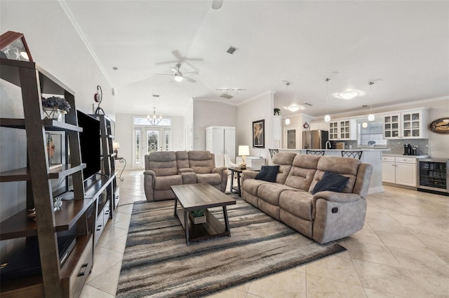 living room with wine cooler, light tile patterned floors, crown molding, and an inviting chandelier