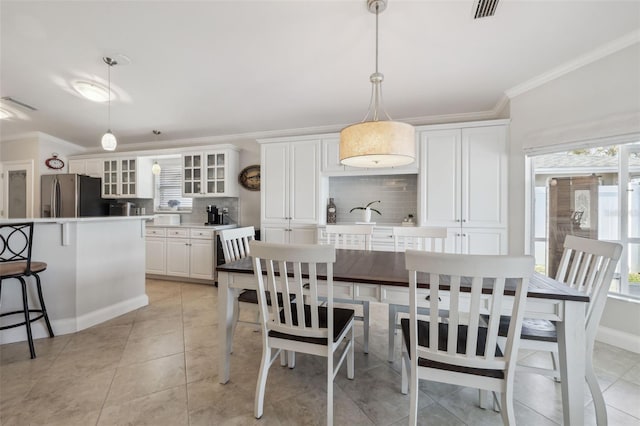 tiled dining room with ornamental molding