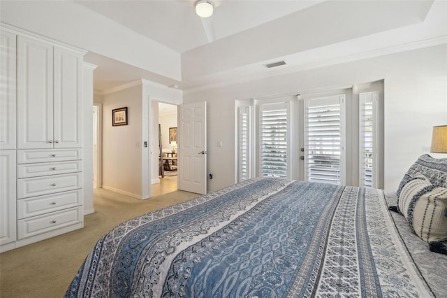 carpeted bedroom featuring a tray ceiling, access to outside, and ornamental molding