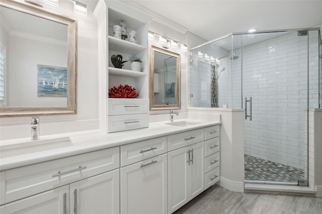 bathroom featuring crown molding, wood-type flooring, vanity, and walk in shower