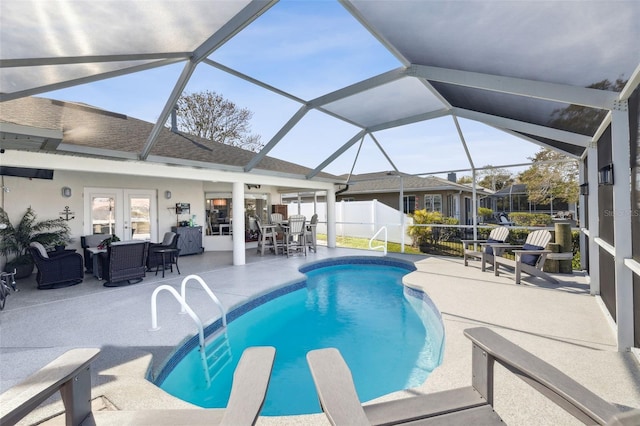 view of swimming pool featuring a lanai, a diving board, a patio area, and french doors