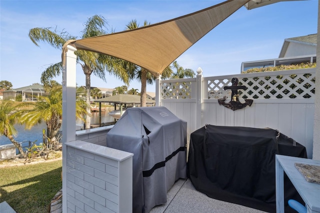 view of patio / terrace featuring a water view and area for grilling