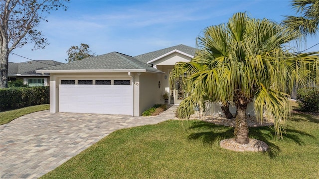 view of front of house with a garage and a front lawn