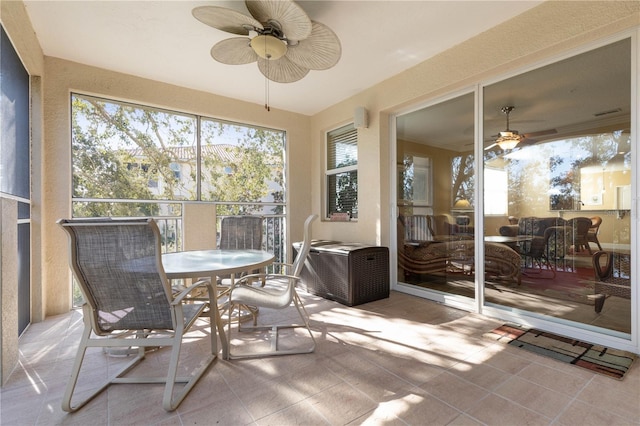 sunroom / solarium featuring ceiling fan