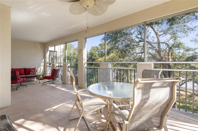 sunroom / solarium featuring ceiling fan