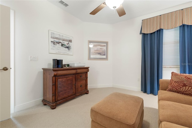 living area with ceiling fan and carpet flooring