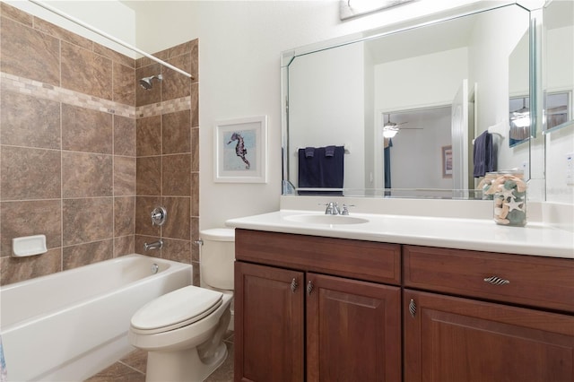 full bathroom featuring vanity, tiled shower / bath, and toilet