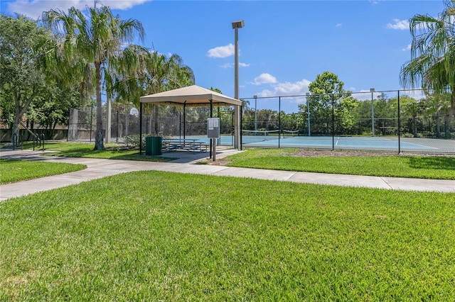 surrounding community featuring a gazebo, tennis court, and a lawn