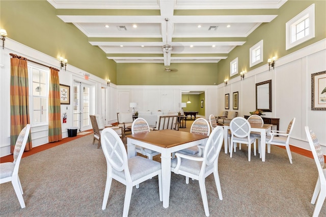 carpeted dining room with plenty of natural light, coffered ceiling, beam ceiling, and french doors