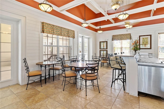 dining space featuring coffered ceiling and beamed ceiling