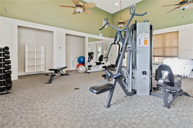 workout area featuring a high ceiling, ceiling fan, and carpet