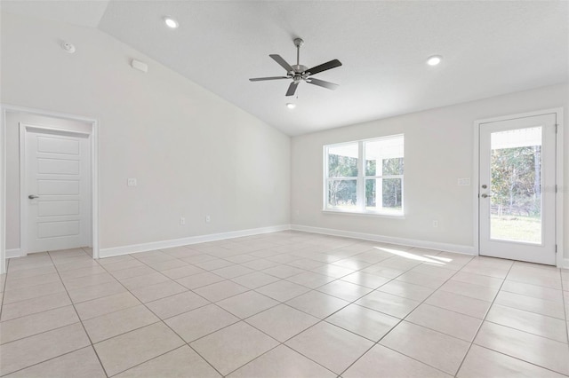 spare room featuring light tile patterned flooring, lofted ceiling, and ceiling fan