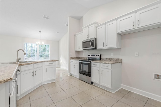 kitchen featuring sink, vaulted ceiling, hanging light fixtures, stainless steel appliances, and white cabinets