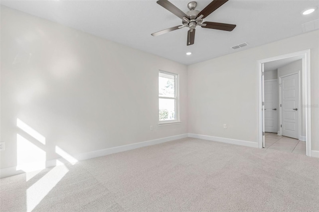 unfurnished bedroom featuring a spacious closet, light carpet, and ceiling fan