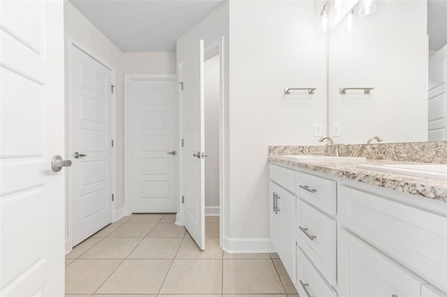 bathroom featuring vanity, tile patterned floors, and a textured ceiling