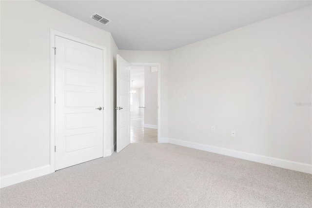 unfurnished bedroom featuring light colored carpet