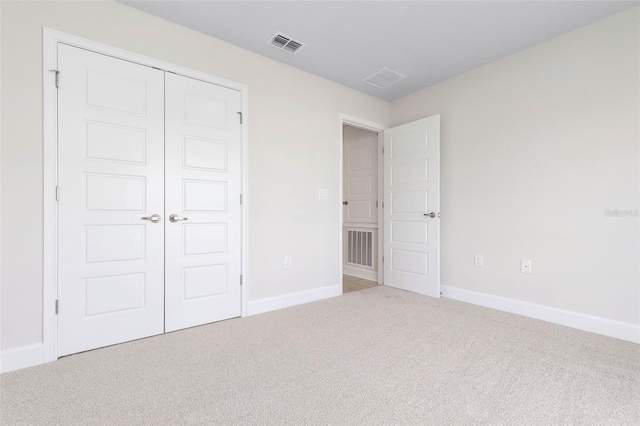 unfurnished bedroom featuring carpet floors and a closet