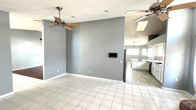 kitchen featuring white cabinetry, ceiling fan with notable chandelier, lofted ceiling, and dishwasher