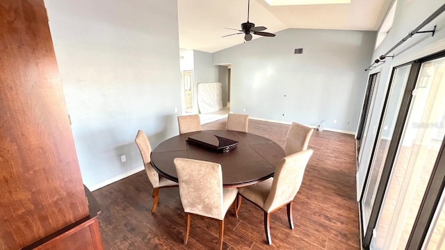 dining space featuring lofted ceiling, dark wood-type flooring, and ceiling fan