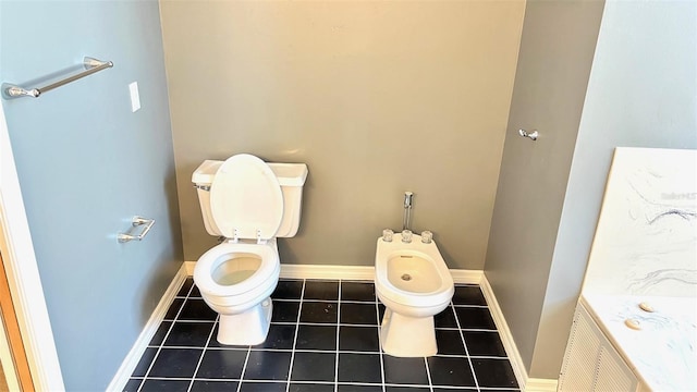 bathroom featuring a bidet, tile patterned flooring, and toilet