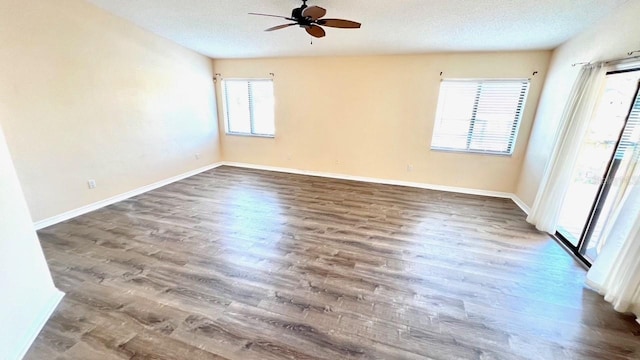 empty room featuring hardwood / wood-style floors, a textured ceiling, and ceiling fan