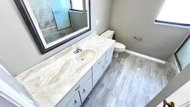 bathroom with hardwood / wood-style flooring, vanity, and toilet