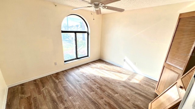 spare room with ceiling fan, hardwood / wood-style flooring, and a textured ceiling