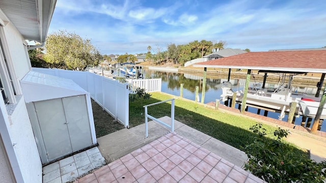 view of patio / terrace with a water view and a boat dock