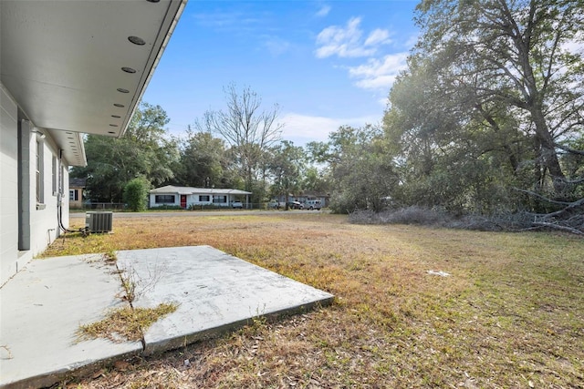 view of yard featuring a patio and central AC