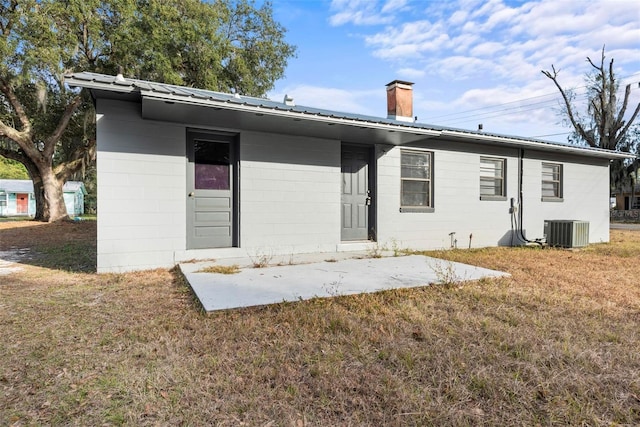 back of property with a patio, cooling unit, and a lawn