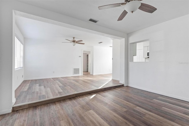 unfurnished room with ceiling fan and hardwood / wood-style floors