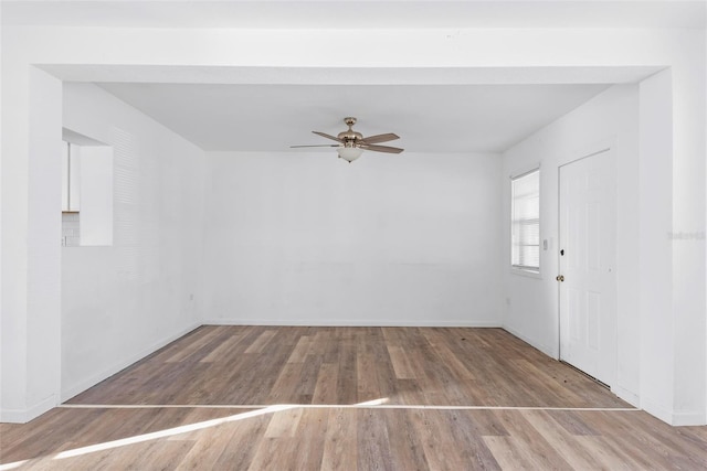 empty room with ceiling fan and light wood-type flooring