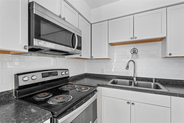 kitchen with sink, backsplash, stainless steel appliances, and white cabinets