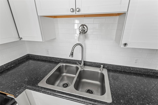 details with white cabinetry, sink, and tasteful backsplash