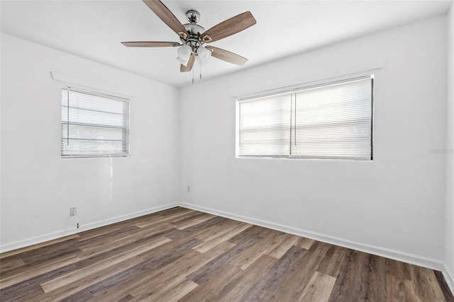 empty room with dark wood-type flooring and ceiling fan