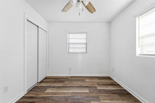 unfurnished bedroom featuring dark hardwood / wood-style flooring, a closet, and ceiling fan