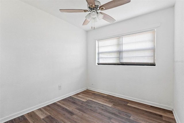 empty room featuring ceiling fan and dark hardwood / wood-style flooring