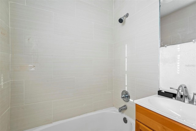 bathroom with vanity and tiled shower / bath combo