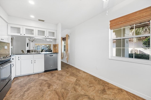 kitchen with tasteful backsplash, white cabinetry, appliances with stainless steel finishes, and plenty of natural light