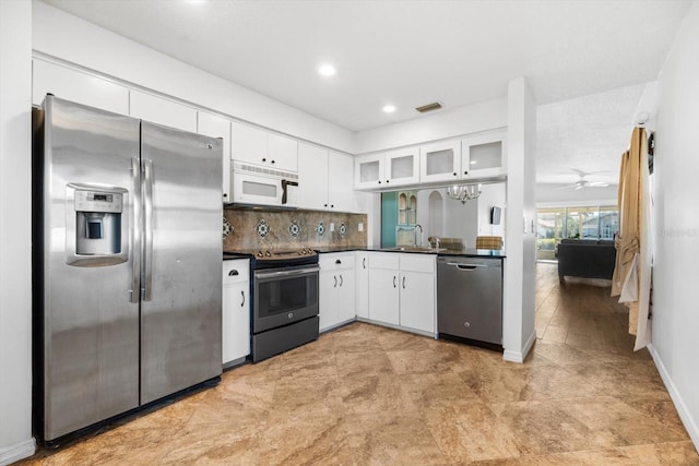 kitchen featuring sink, tasteful backsplash, ceiling fan, stainless steel appliances, and white cabinets