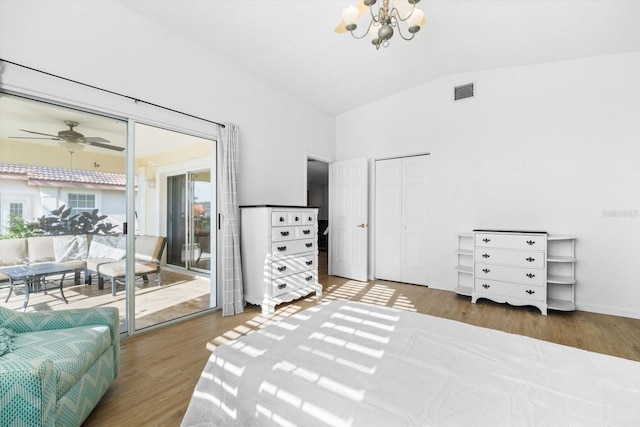 bedroom featuring a notable chandelier, lofted ceiling, hardwood / wood-style floors, and access to outside