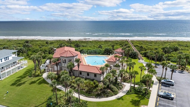 bird's eye view featuring a water view and a beach view